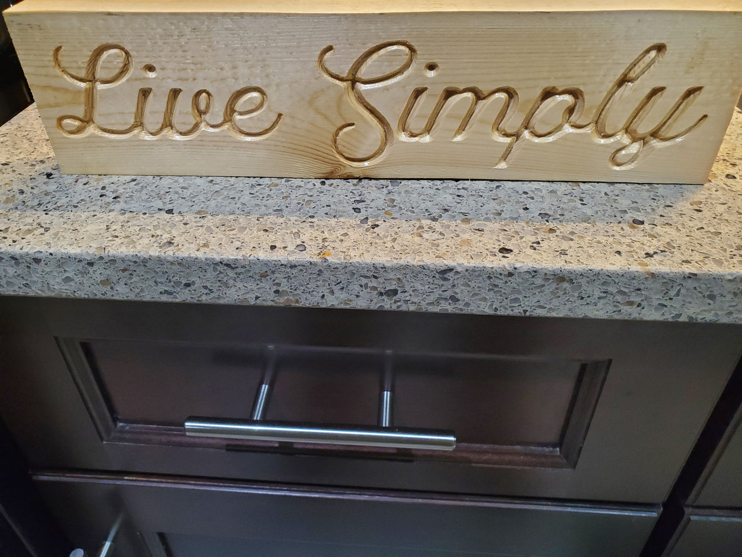 Live Simply carved sign