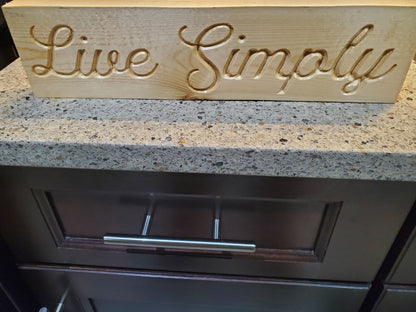 Live Simply carved sign