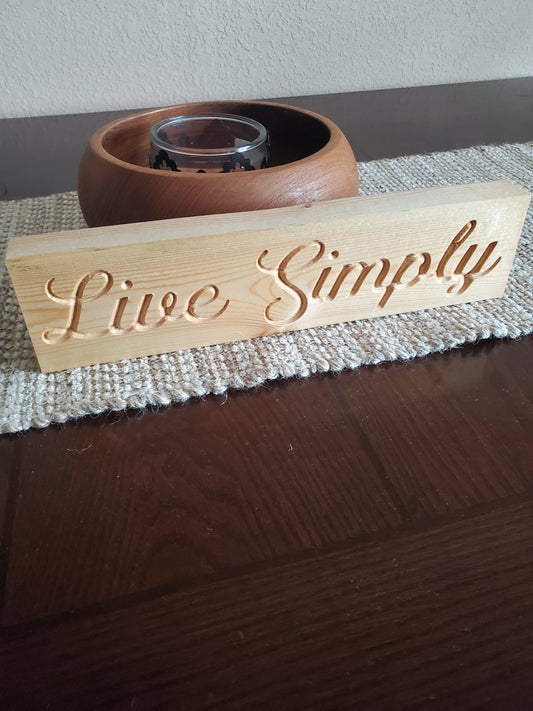 Live Simply carved sign